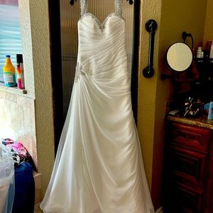 Wedding dress bought off the rack. Never worn or altered. Super stunning!